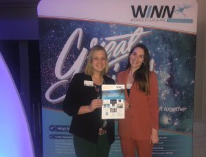 Janina Neumann and Dr Carla Brown holding a certificate at WINN event
