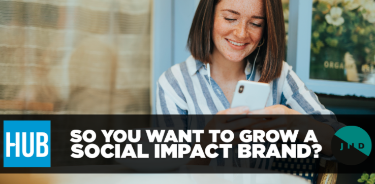 Young woman looking at her phone smiling, text 'So you want to grow a social impact brand?'